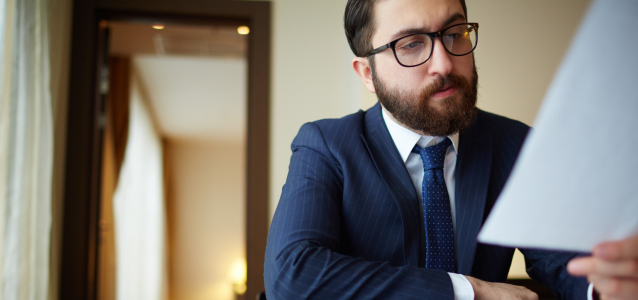 Quinn Advisory Group consultant reviewing carrier management and retirement plan documents for funeral home owners